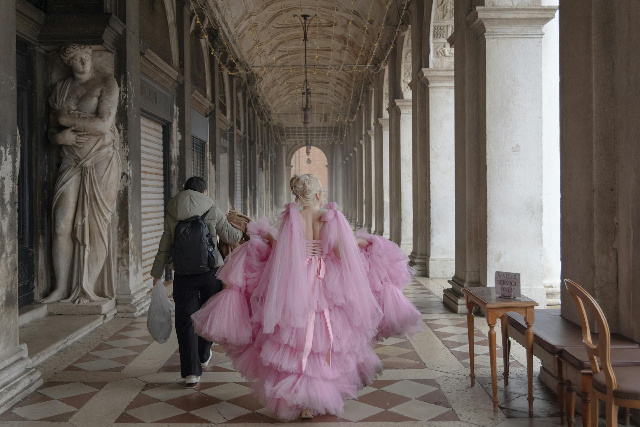 A tourist is dressed up for a private photo shoot in St. Mark's Square in Venice in February.