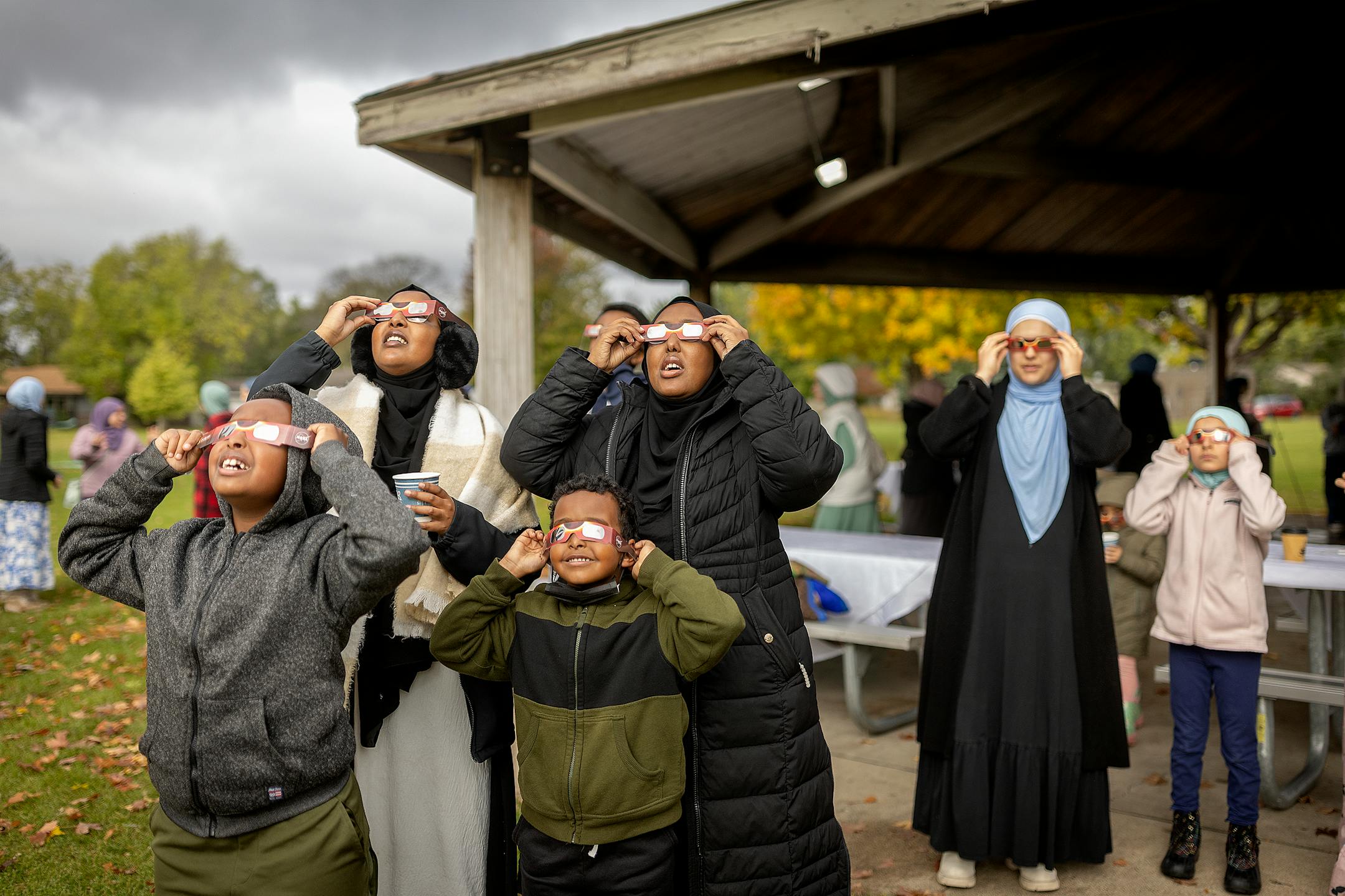 Muslims view the annular Eclipse as the clouds break during a viewing event at Commons Park in Fridley, Minn., on Saturday, Oct. 14, 2023. Local NASA/Jet Propulsion Laboratory Solar System Ambassador Nadia Abuisnaineh, cq, hosted a viewing event for the Muslim community with an eclipse prayer known as Salaatul Kusoof. The Salatul Kusoof is a prayer in the Muslim faith known as the "eclipse prayer," which occurs when the moon comes between the sun and Earth. Prayer, activities and warm drinks were also part of the event.