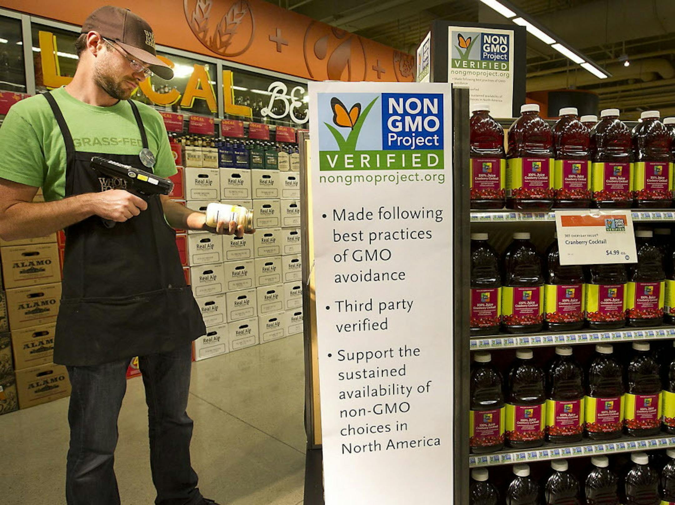 Whole Foods Market, headquartered in Austin, Texas, plans to add more than 30 stores this year, a record for the chain. But even as it expands it faces challenges from other grocers such as Trader Joes. Employee Ian Purdue scans products at a store in Austin in April 2013. (Ralph Barrera/Austin American-Statesman/MCT) ORG XMIT: 1146596