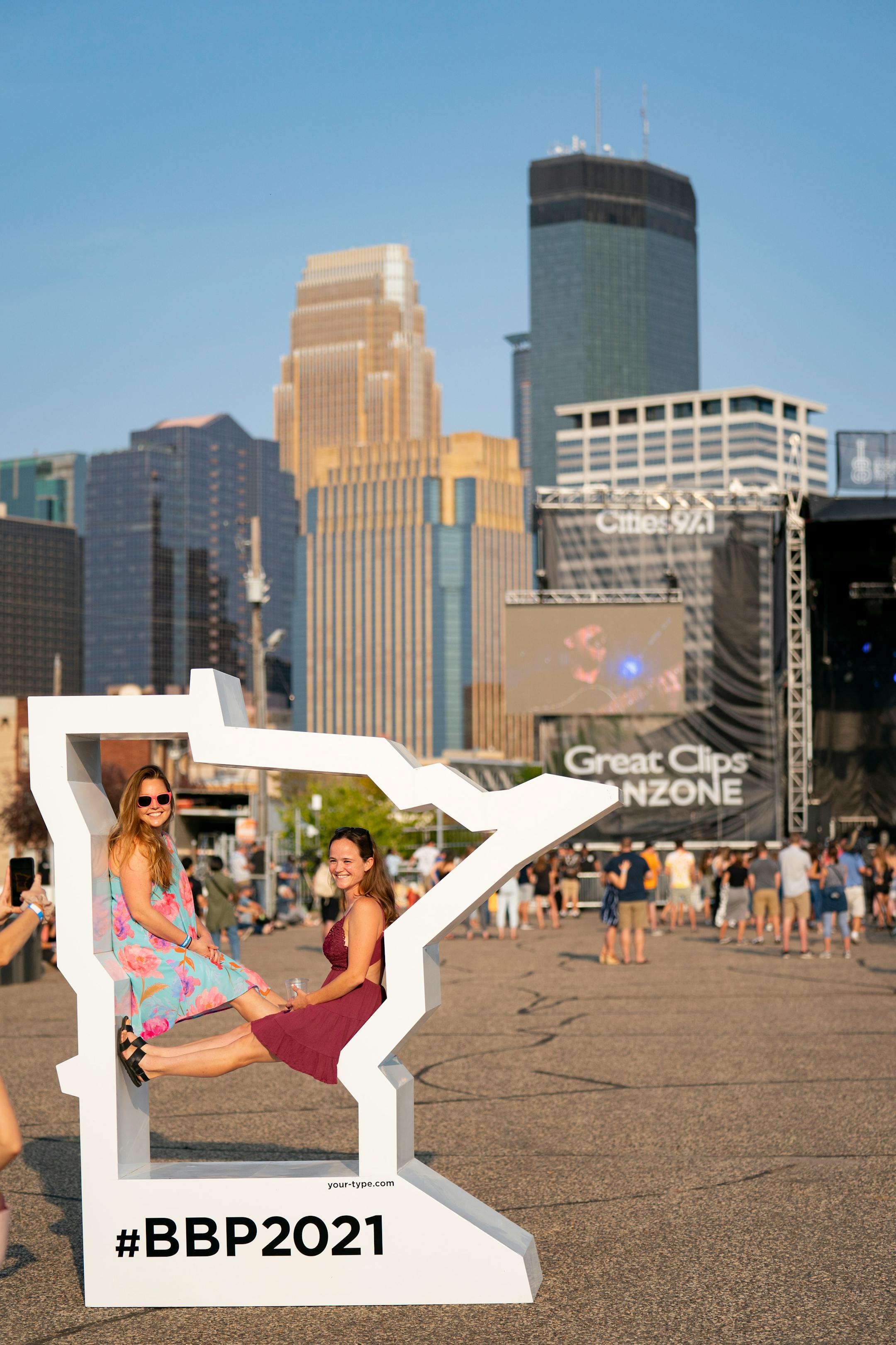 From left, Rachel Freeman and Maggie Webb posed for a photo in front of the Great Clips Stage at the Basilica Block Party on Friday evening.