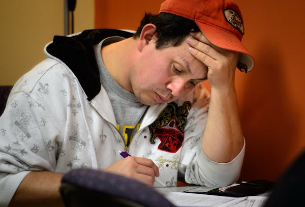 Raul Chavez of Shakopee held his head as he started on his MNsure application at Portico Health Monday afternoon. Portico HealthNet in St. Paul was ta