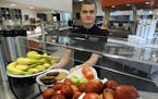 Sam Leikind, a culinary student at Minnesota Life College, set out food at the cafe at Best Buy headquarters in Richfield.