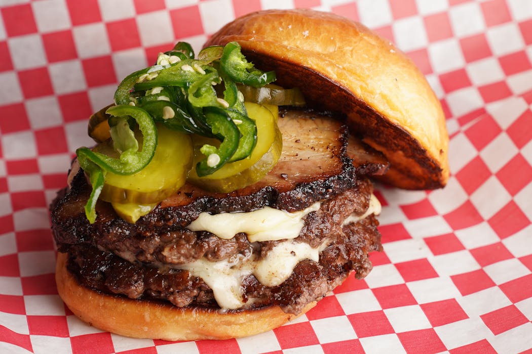 Animales Burger Co.’s double cheeseburger with pork belly, pickles, and jalapeños 