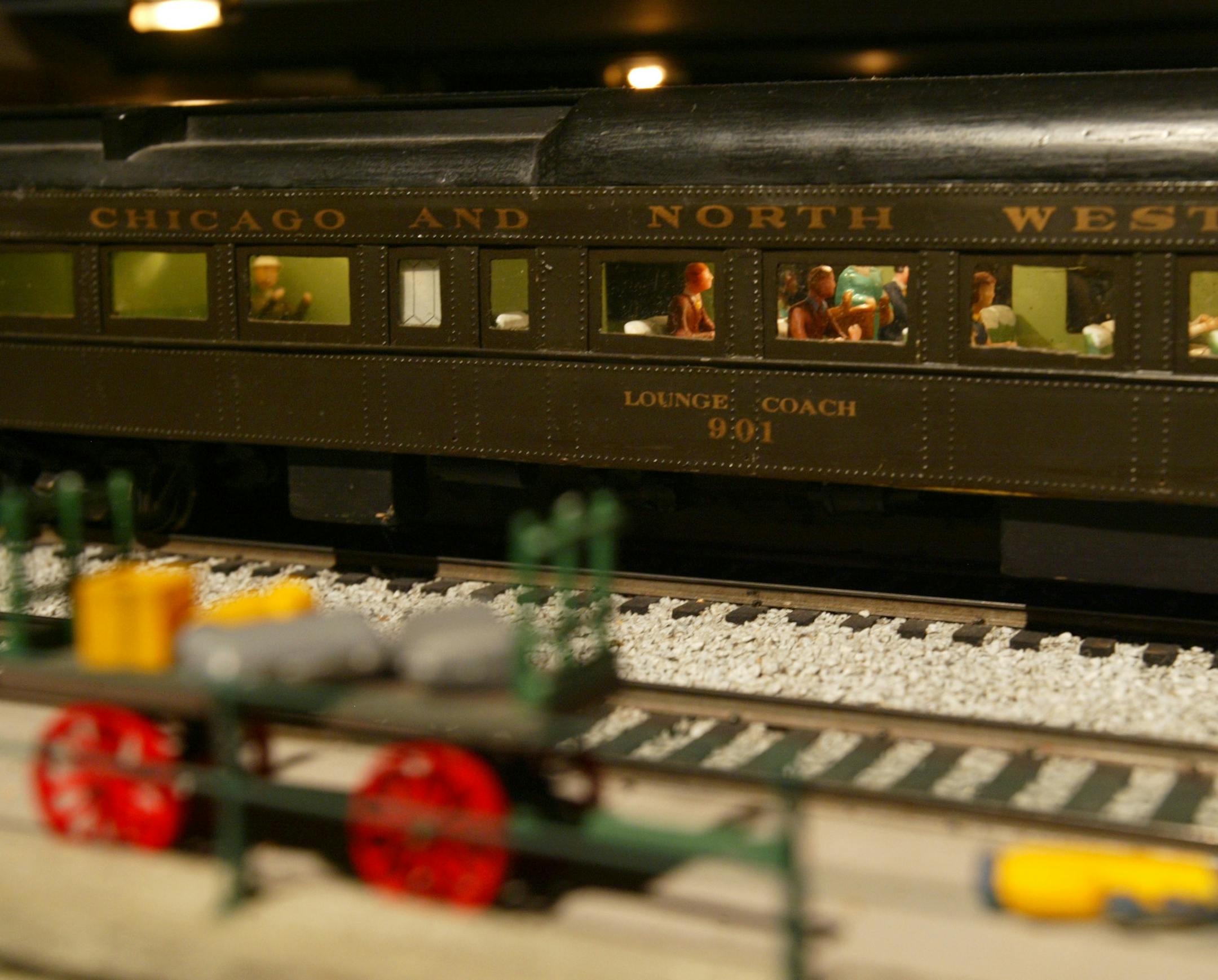 Detail of the passengers in a rail car in the display at the Twin City Model Railroad Museum.
GENERAL INFORMATION: ST. PAUL - 12/18/02 - The Twin City Model Railroad Museum is featuring their popular "Night Trains" show Saturday nights through February 22nd at their exhibiton space in St. Paul's Bandana Square. One of their featured trains, a model of the 1948 Northern Pacific North Coast Limited, will also be on display at the upcoming model railroading convention at Canterbury Park.