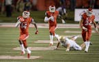 Fresno State's Jaron Bryant, left, runs a blocked field goal back for a touchdown against Idaho during an NCAA college football game Saturday, Sept. 1