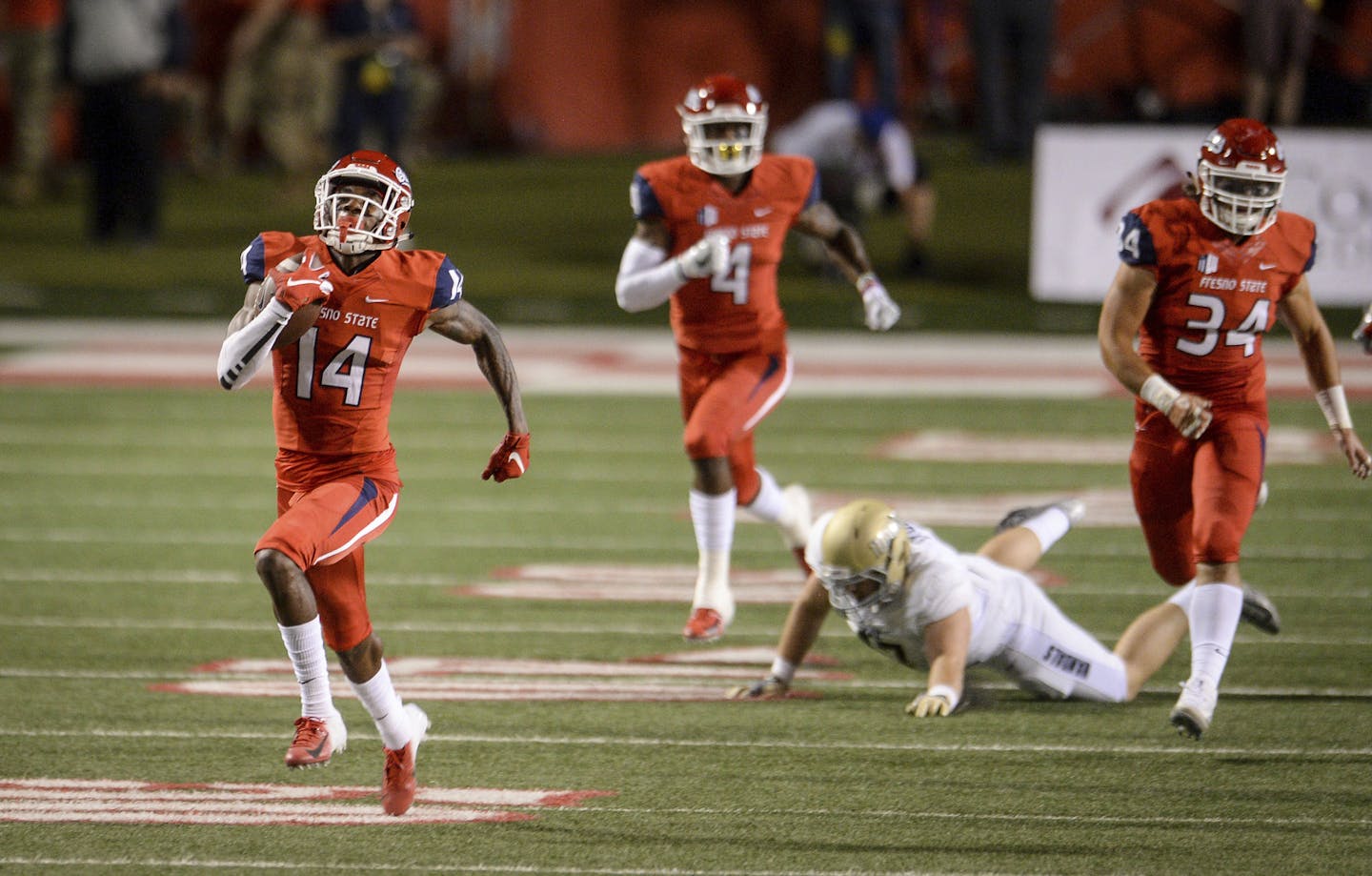 Fresno State's Jaron Bryant, left, runs a blocked field goal back for a touchdown against Idaho during an NCAA college football game Saturday, Sept. 1, 2018, in Fresno, Calif. Bryant ran another blocked field goal kick back for a touchdown later in the first half. (Craig Kohlruss/The Fresno Bee via AP)