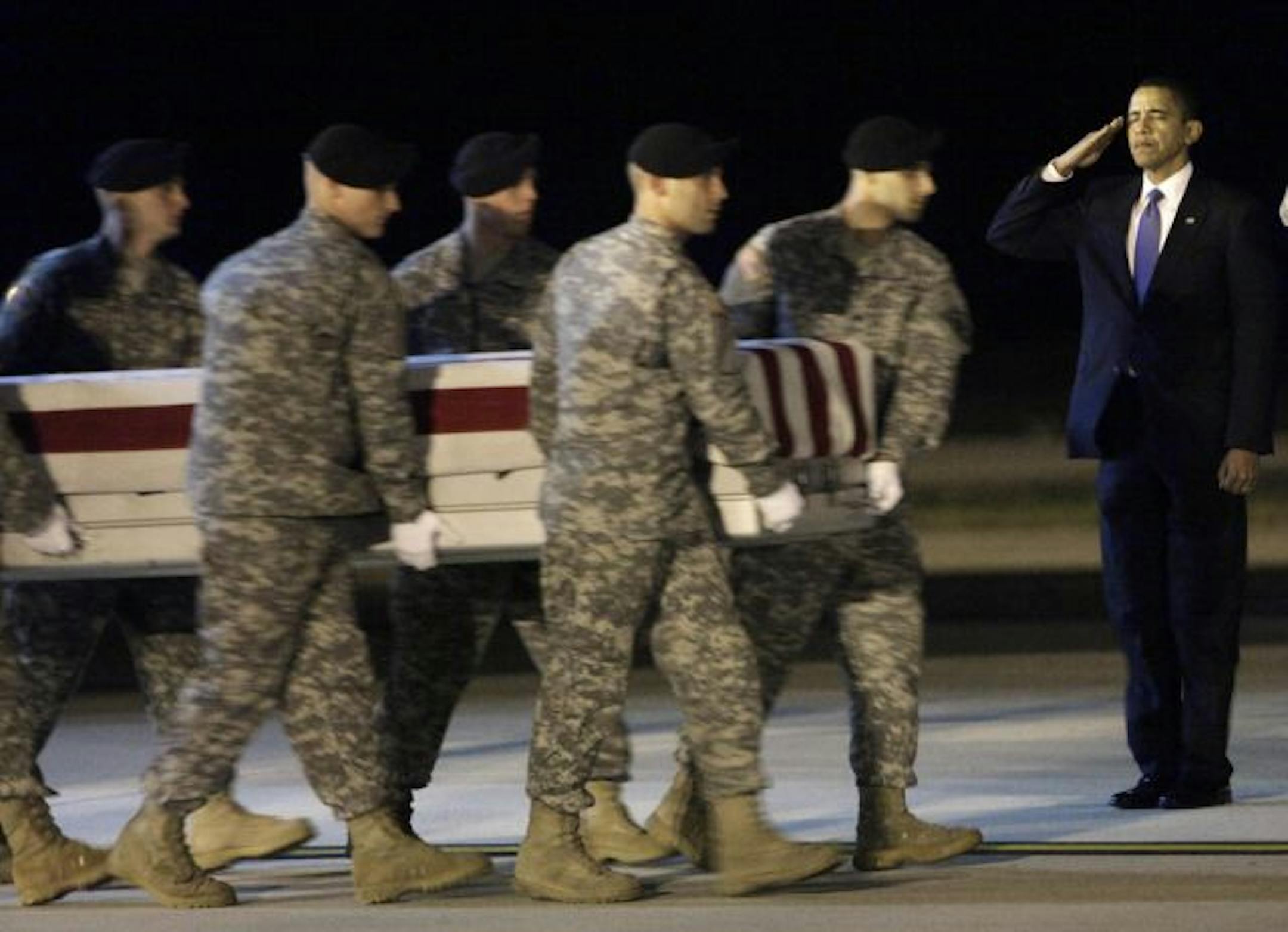 President Obama, right, at Dover Air Force Base last week: His impeccable salute honored the fallen servicemen being brought back home..