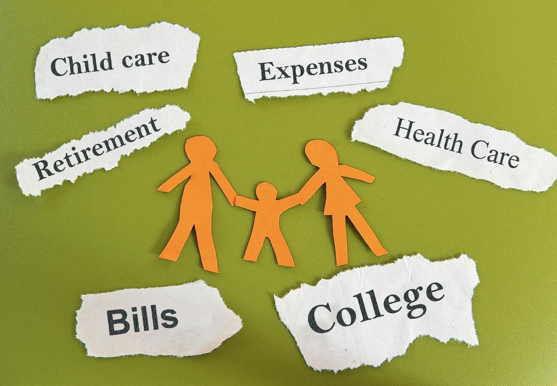 Paper cutout family with expenses on torn paper scraps