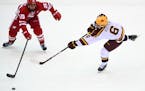 Gophers defenseman Mike Koster tried to get a shot around Wisconsin’s Dominick Mersch during a game at Mariucci Arena two weeks ago.