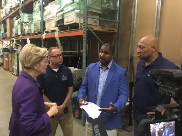 Sen. Elizabeth Warren spoke with Better Futures Minnesota President Thomas Adams and other staff at the nonprofit's Minneapolis warehouse Tuesday, whe