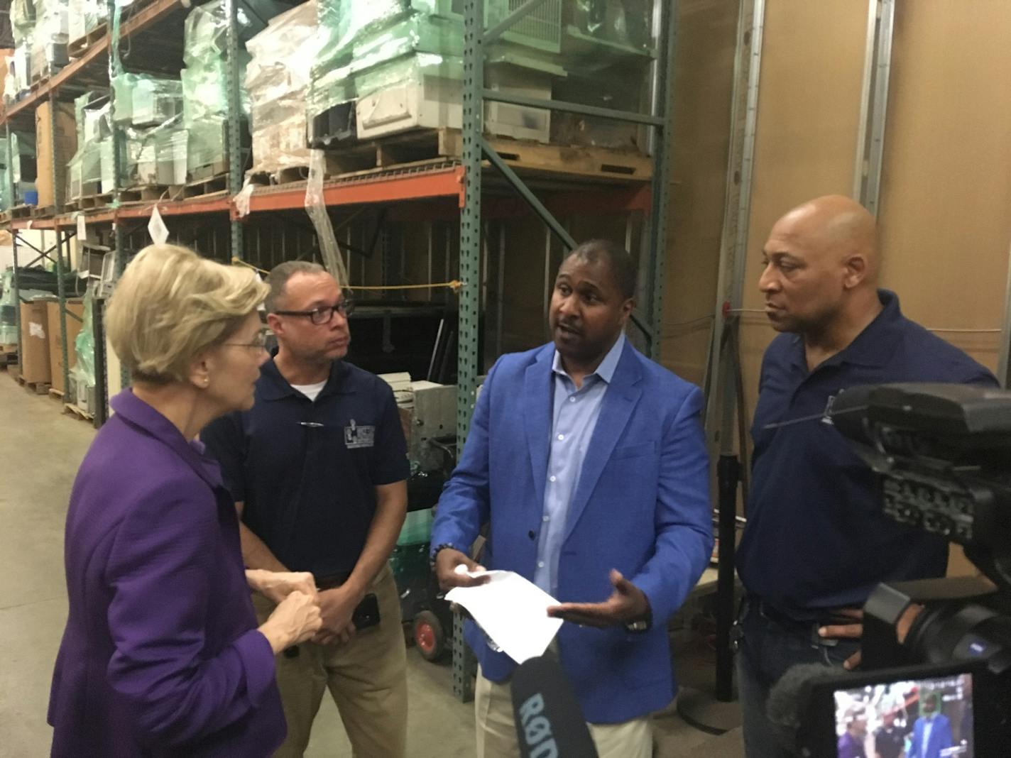 Sen. Elizabeth Warren spoke with Better Futures Minnesota President Thomas Adams and other staff at the nonprofit's Minneapolis warehouse Tuesday, where Warren held a criminal justice reform roundtable.