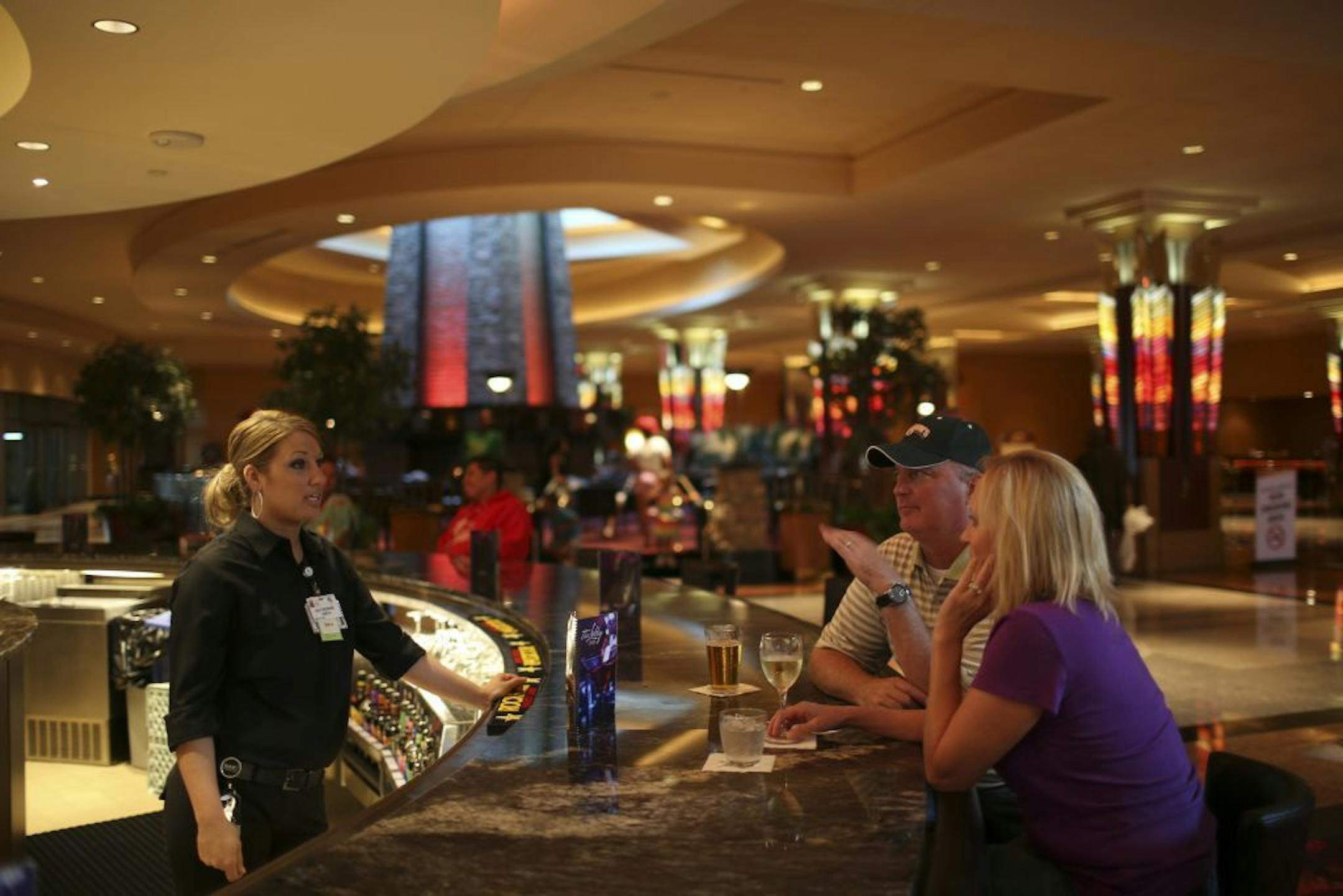 Mystic Lake Casino was a "dry" establishment for many years until it quietly began serving alcohol last year. Now it's ready to make a bigger splash, with three new bars on the casino floor and a grand opening bash Saturday aimed at courting the nightclubbing crowd. Bartender Katie Stirzl chatted with patrons Scott and Jodi Rassett of Prior Lake in the Lobby Lounge Monday night, August 19, 2013, one of the new bars at Mystic Lake Casino in Prior Lake.