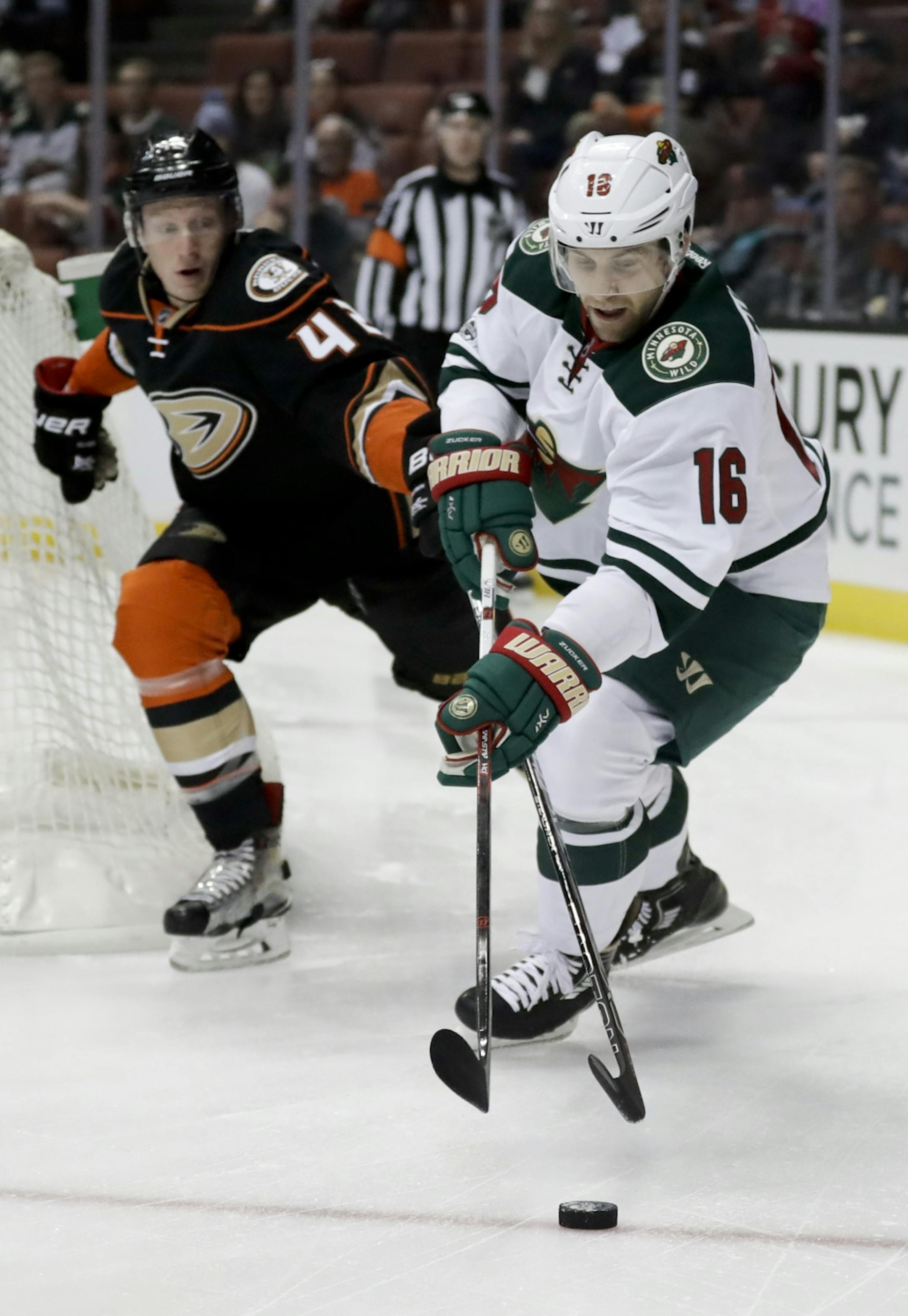 Minnesota Wild left wing Jason Zucker right, vies for the with Anaheim Ducks defenseman Josh Manson during the first period of an NHL hockey game in Anaheim, Calif., Sunday, Jan. 8, 2017.