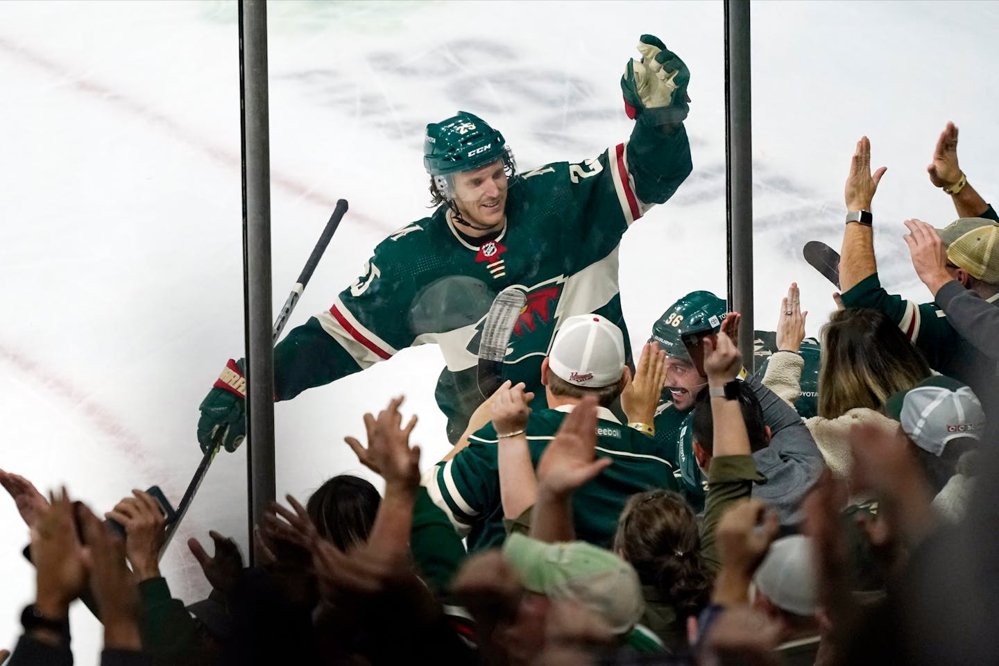 Minnesota Wild's Jonas Brodin, center, joins the celebration after a goal.