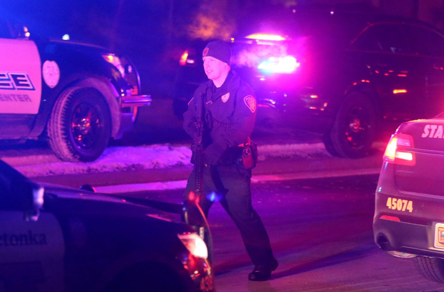 An armed police officer walked near the scene of an active shooting Friday, Feb. 12, 2016, in Plymouth, MN.](DAVID JOLES/STARTRIBUNE)djoles@startribune.com Guy ran over and shot someone at Rockford Road and Northwest Boulevard in Plymouth. Then he took off to his apartment and is holed up in a bulletproof vest and shooting out the window.