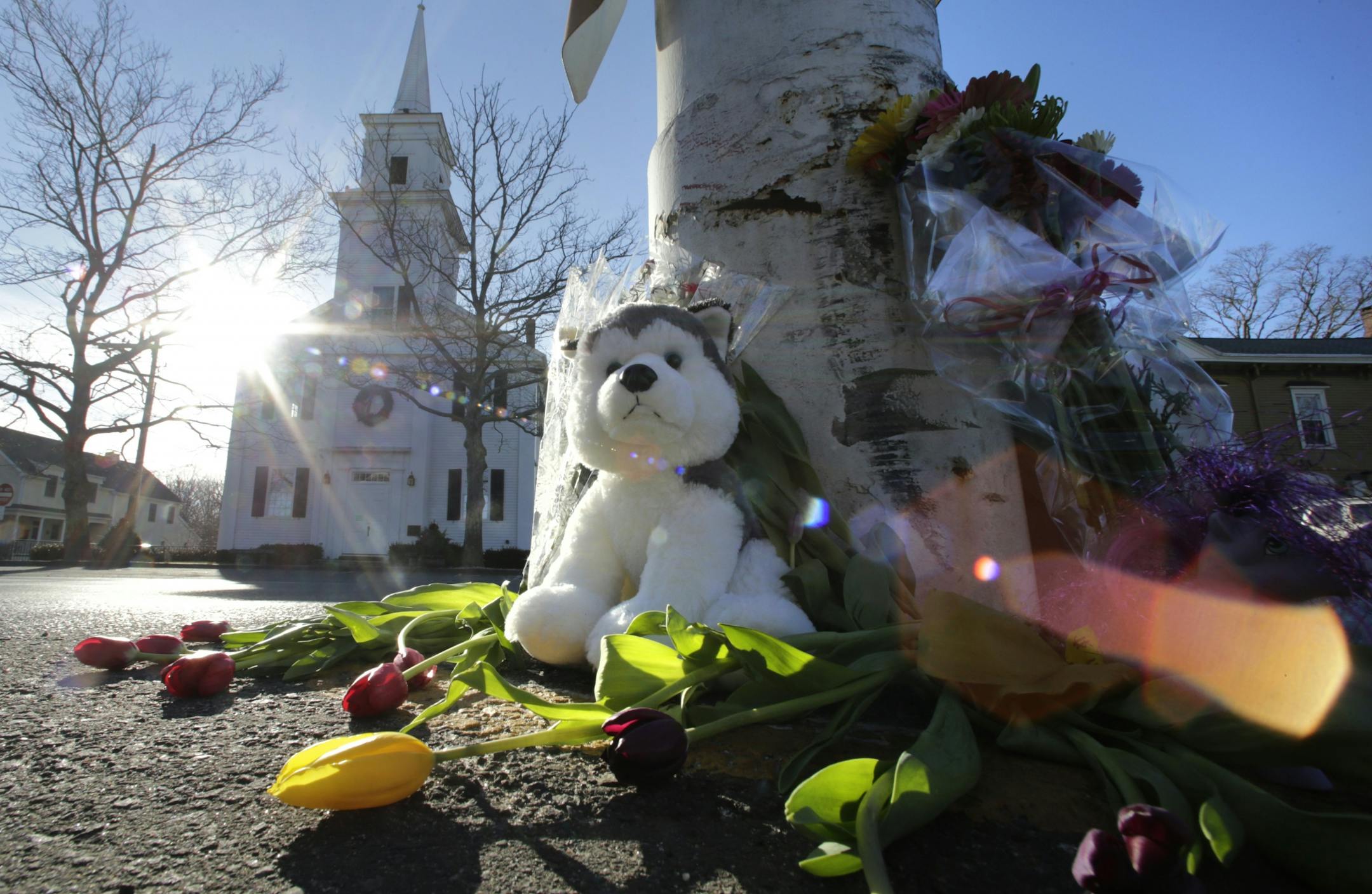 Flowers and stuffed animals of a makeshift memorial for school shooting victims encircle the flagpole at the town center in Newtown, Conn., Saturday, Dec. 15, 2012. The massacre of 26 children and adults at Sandy Hook Elementary school elicited horror and soul-searching around the world even as it raised more basic questions about why the gunman, 20-year-old Adam Lanza, would have been driven to such a crime and how he chose his victims.