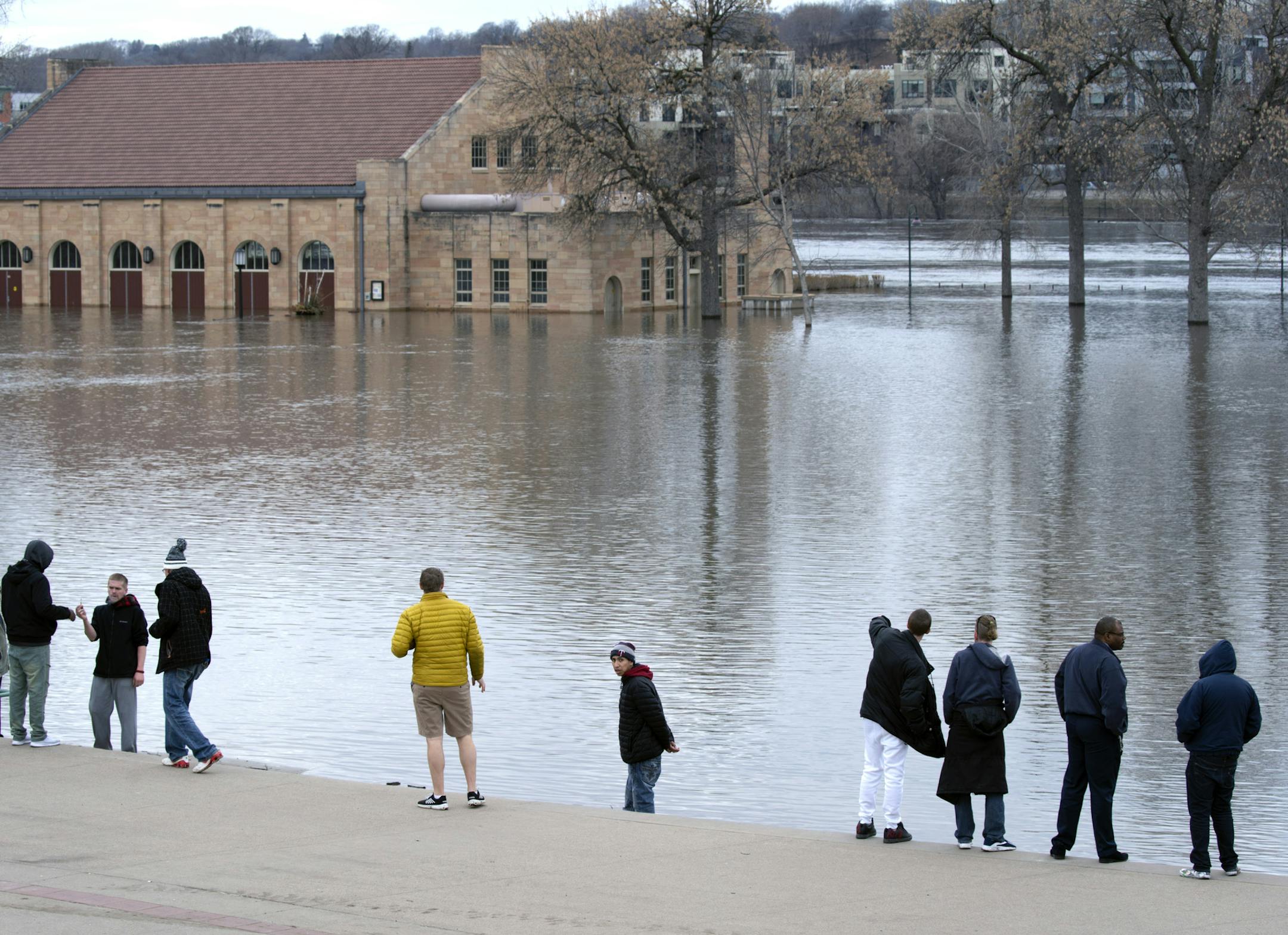 The Mississippi River crested in St. Paul overnight, and is now starting to ever so slightly recede. Harriet Island Pavilion is surrounded by water, with the river now extending to the park steps, where gawkers gather to watch the historic river rise. ]
brian.peterson@startribune.com
St. Paul, MN Monday, April 1, 2019
