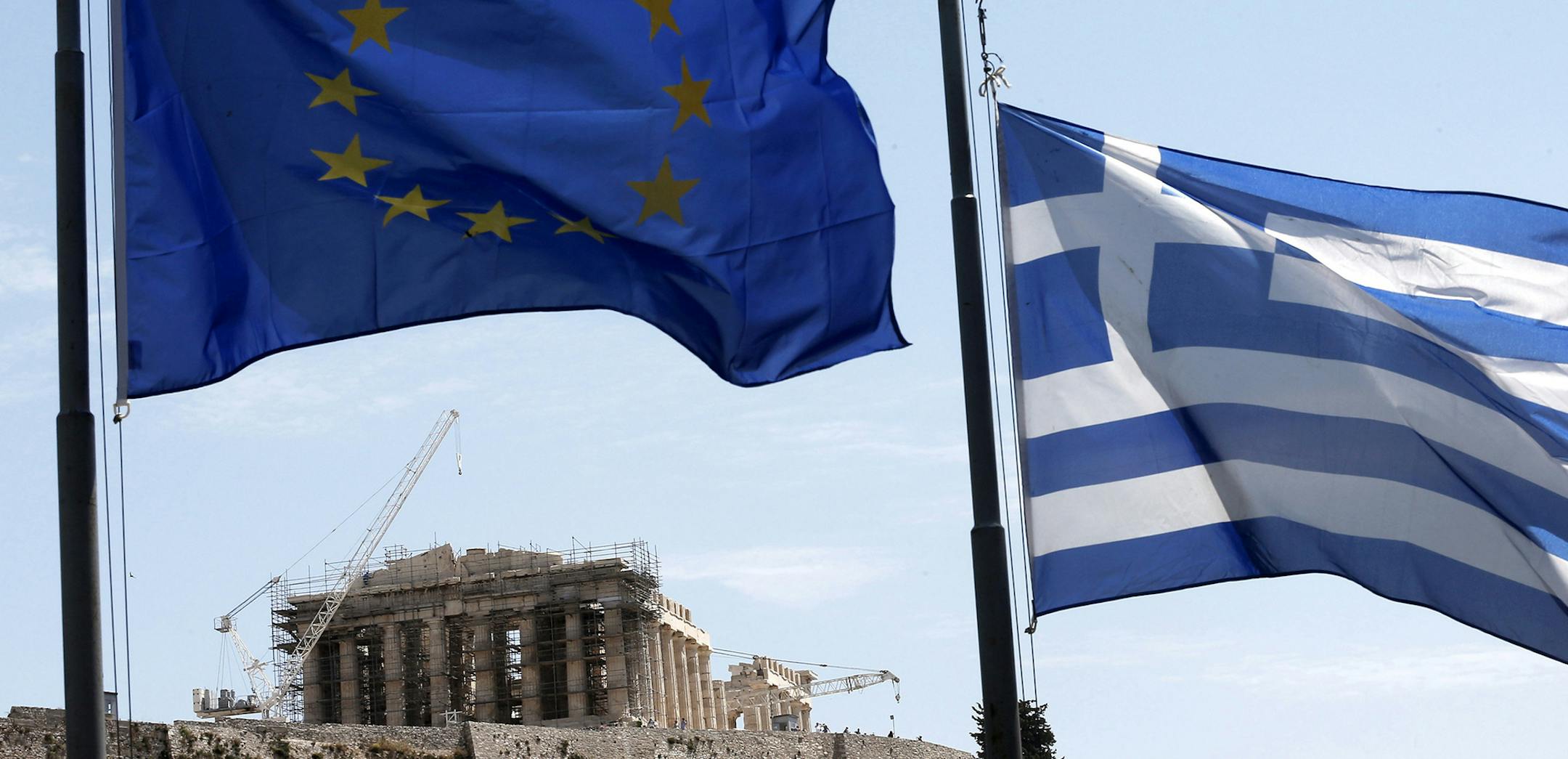 A Greek and a European Union flag billow in the wind as the ruins of the fifth century BC Parthenon temple are seen in the background on the Acropolis hill, Athens, Wednesday, June 3, 2015. Greece's prime minister was heading to high-level meetings in Brussels on Wednesday to try to persuade the country's creditors to accept a proposal that might unlock much-delayed bailout loans and save the country from financial disaster. (AP Photo/Petros Giannakouris) ORG XMIT: MIN2015062411223253