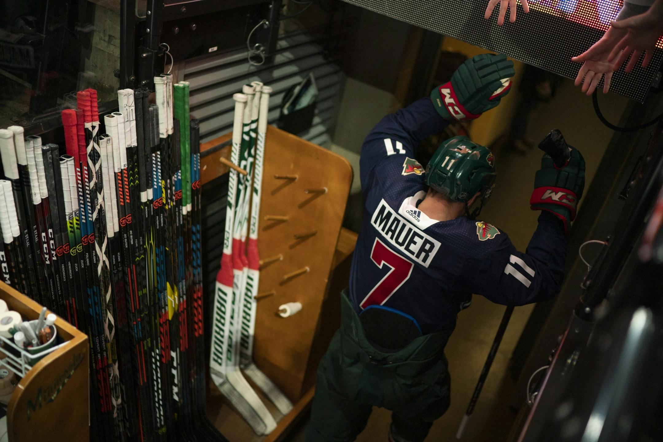 Minnesota Wild left wing Zach Parise (11) and the rest of the team wore Joe Mauer tribute sweaters during their pregame warmups Tuesday night.