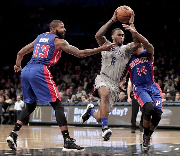 Brooklyn Nets guard Sean Kilpatrick (6) drives against Detroit Pistons forward Marcus Morris (13) and guard Ish Smith (14) during the third quarter of