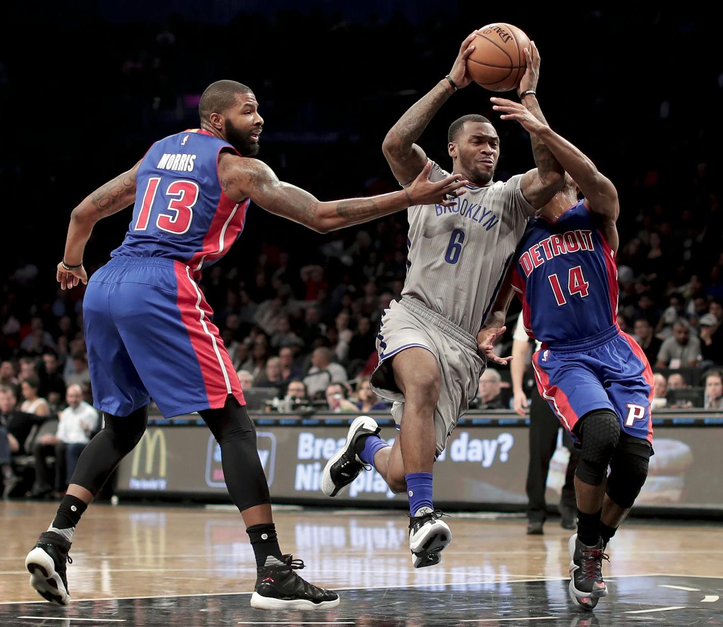 Brooklyn Nets guard Sean Kilpatrick (6) drives against Detroit Pistons forward Marcus Morris (13) and guard Ish Smith (14) during the third quarter of an NBA basketball game, Wednesday, Nov. 2, 2016, in New York. The Nets won 109-101. (AP Photo/Julie Jacobson)