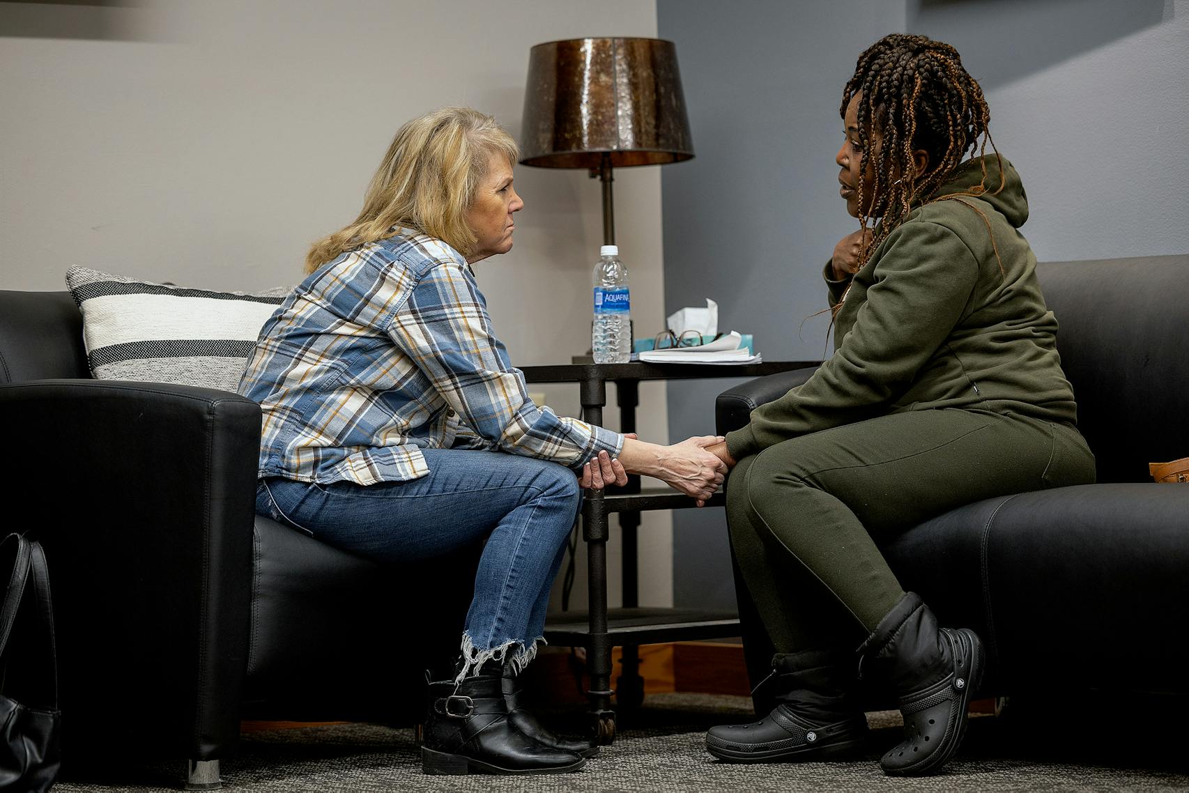 Before a support group meeting, Pam Lanhart talked with Holly Marshall, who told about her son's battle with addiction. 