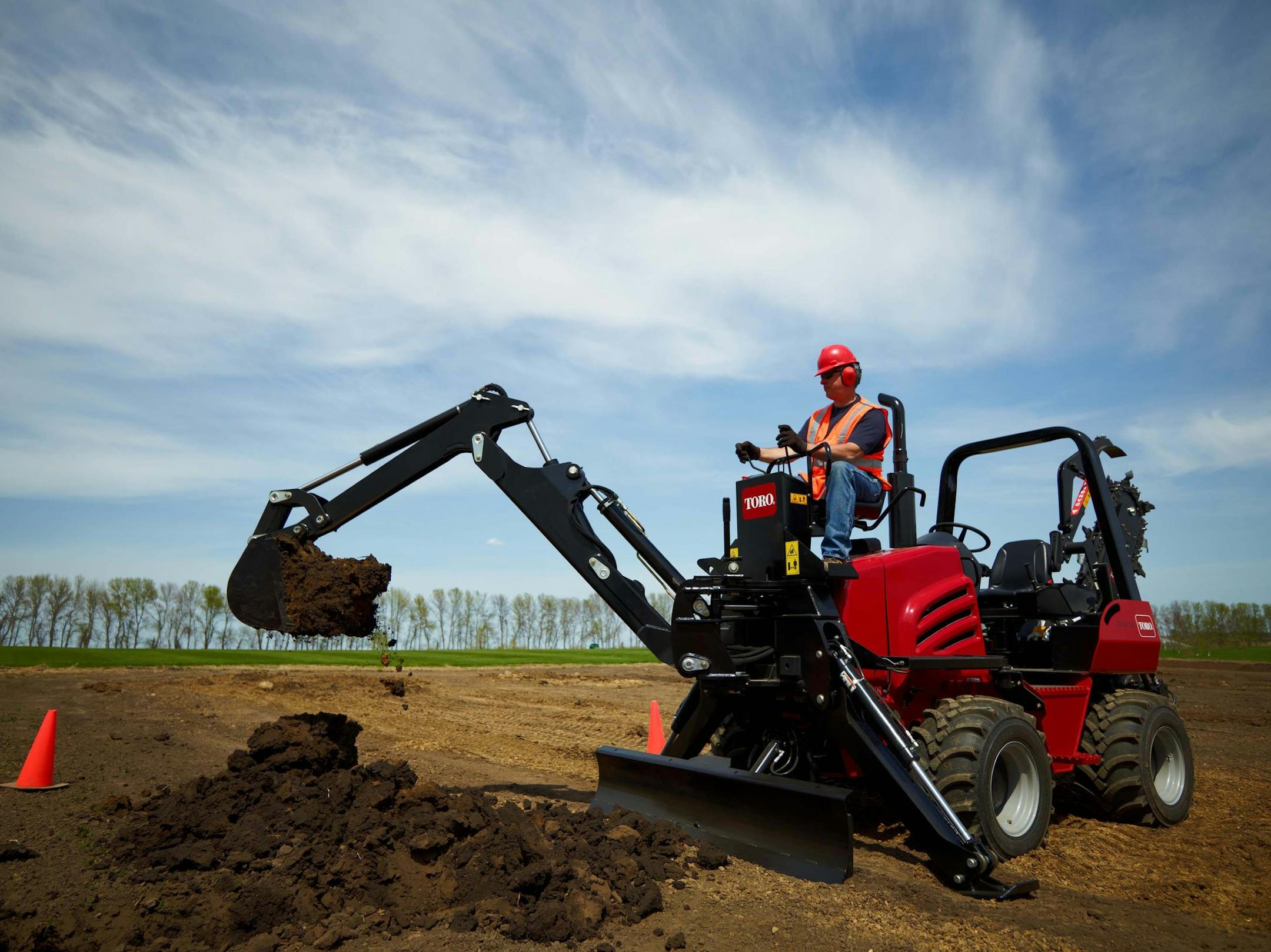 Toro&#x201a;&#xc4;&#xf4;s RT600 trencher with backhoe attachment being used to create a pit for connecting underground utilities at a jobsite. Credit: Toro