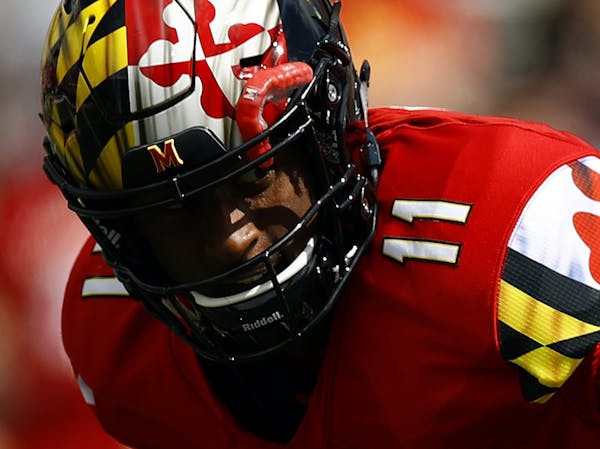 Maryland quarterback Kasim Hill, left, is sacked by Temple defensive tackle Michael Dogbe, center, and defensive end Jimmy Hogan in the first half of 