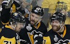 Pittsburgh Penguins' Ron Hainsey, center, celebrates his goal against the Nashville Predators with Evgeni Malkin, left, and Phil Kessel, right, during