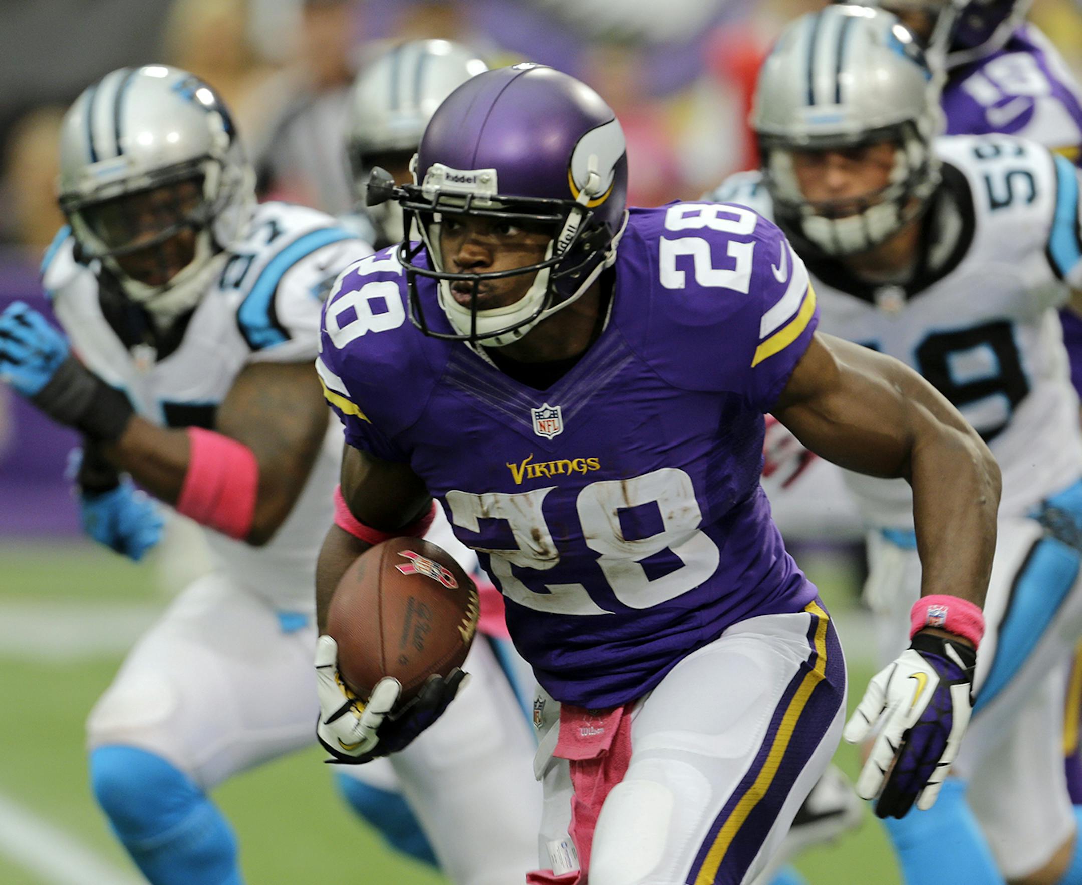 Minnesota Vikings running back Adrian Peterson runs against the Carolina Panthers during the first half of an NFL football game in Minneapolis, Sunday, Oct. 13, 2013. (AP Photo/Ann Heisenfelt) ORG XMIT: MIN2013101414113123