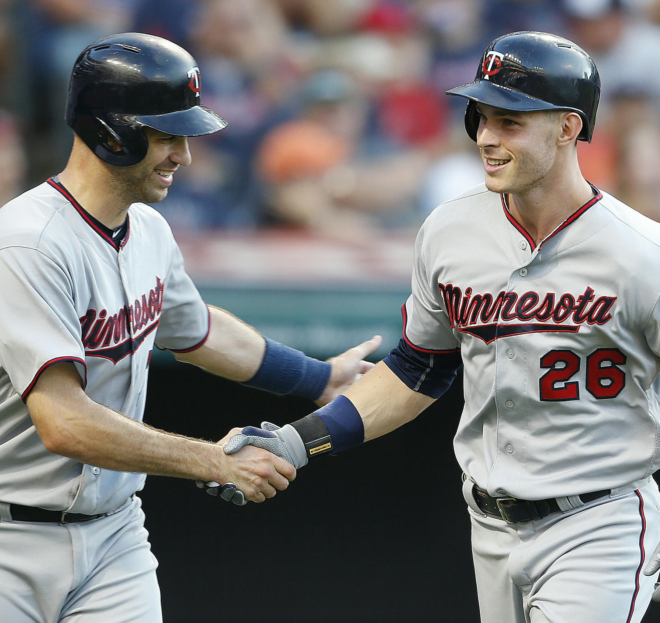 Minnesota Twins' Max Kepler (26) gets congratulations from Joe Mauer after hitting a two run home run off Cleveland Indians starting pitcher Danny Salazar during the third inning of a baseball game, Monday, Aug. 1, 2016, in Cleveland. (AP Photo/Ron Schwane)