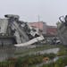 Rescuers work among the rubble of the collapsed Morandi highway bridge in Genoa, northern Italy, Tuesday, Aug. 14, 2018. A large section of the bridge