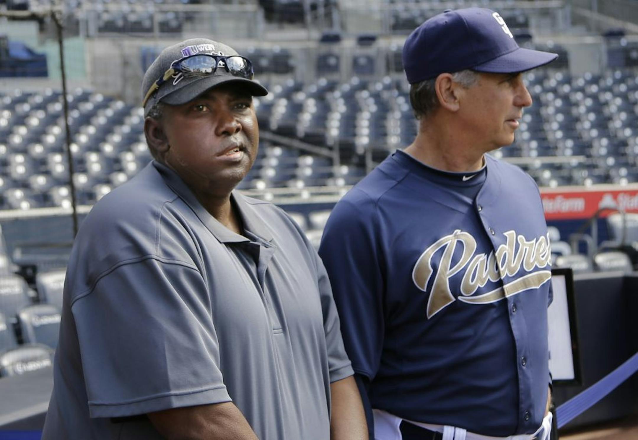 In this June 11, 2013, photo, Hall-of-Fame baseball player Tony Gwynn, left, watches with Padres manager Bud Black as Padres players prepare for a baseball game in San Diego.