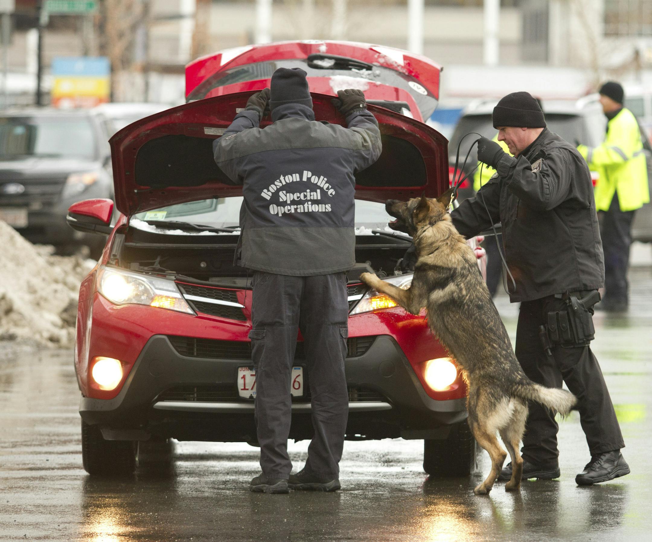 Boston Police search cars outside the John Joseph Moakley Courthouse in Boston, the morning of March 4, 2015. Opening arguments in the trial of Dzhokhar Tsarnaev, charged in the 2013 Boston Marathon bombings that killed three and injured 260, began there Wednesday. (Erik Jacobs/The New York Times)
