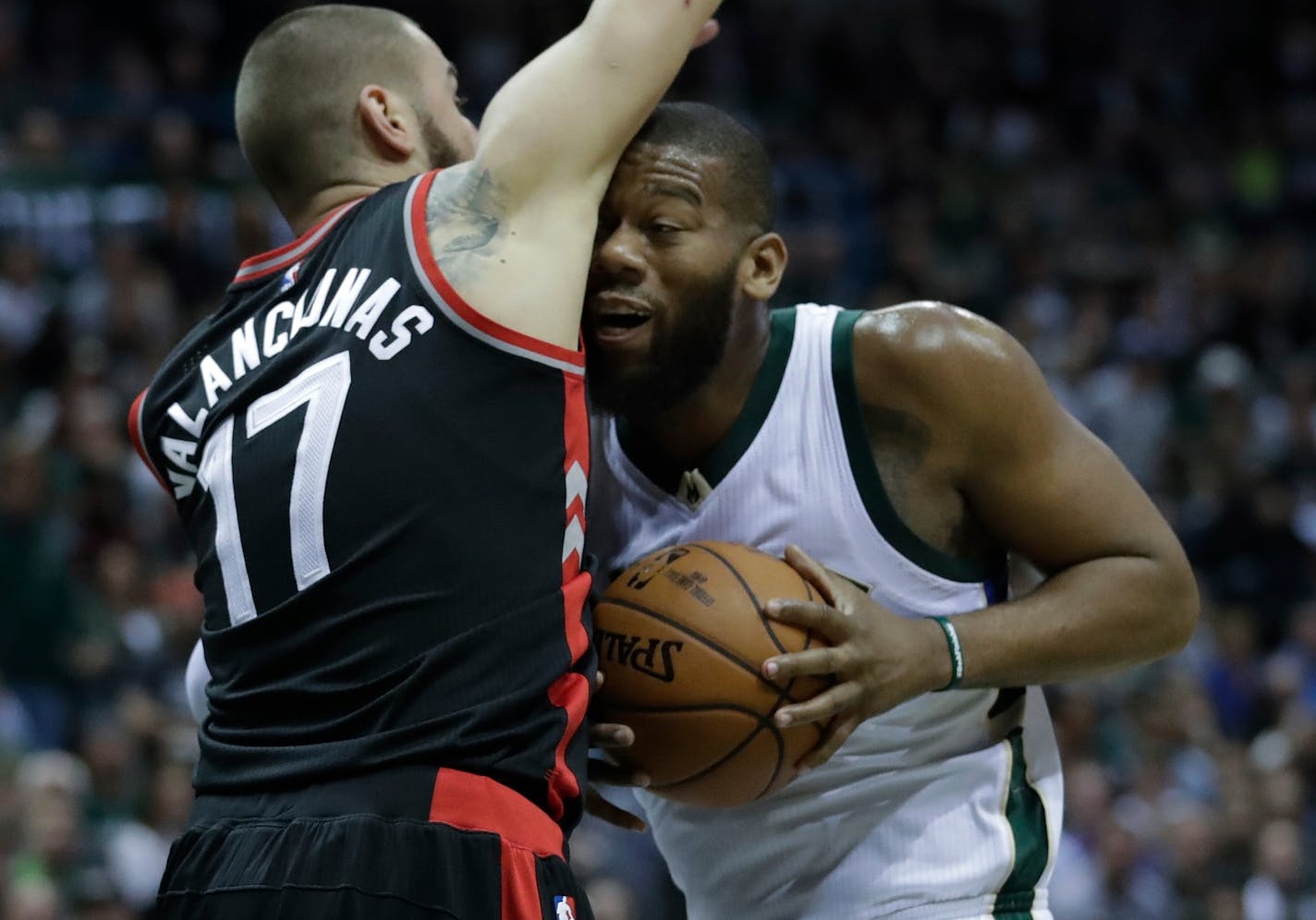 Milwaukee Bucks' Greg Monroe runs into Toronto Raptors' Jonas Valanciunas (17) during the second half of Game 4 of an NBA first-round playoff series basketball game Saturday, April 22, 2017, in Milwaukee. The Raptors won 87-76 to tie the series 2-2. (AP Photo/Morry Gash)