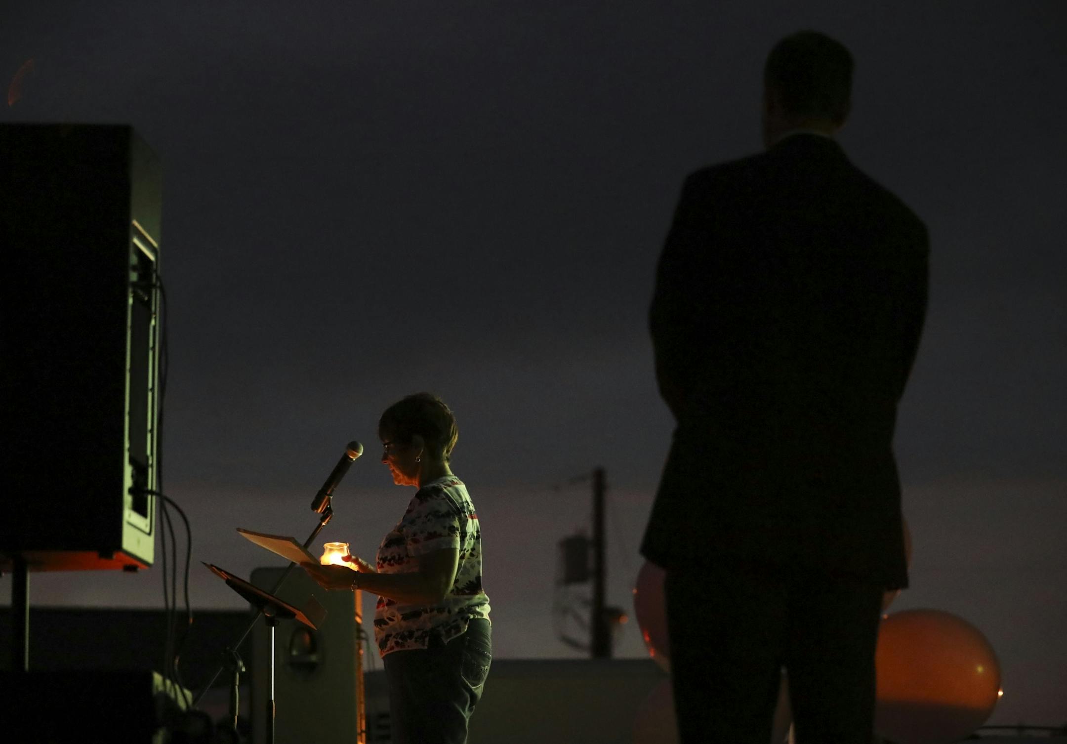 Kathy Pauls sang during the prayer vigil for Alayna Ertl Tuesday night in the parking lot of St. Anthony Church in Watkins.