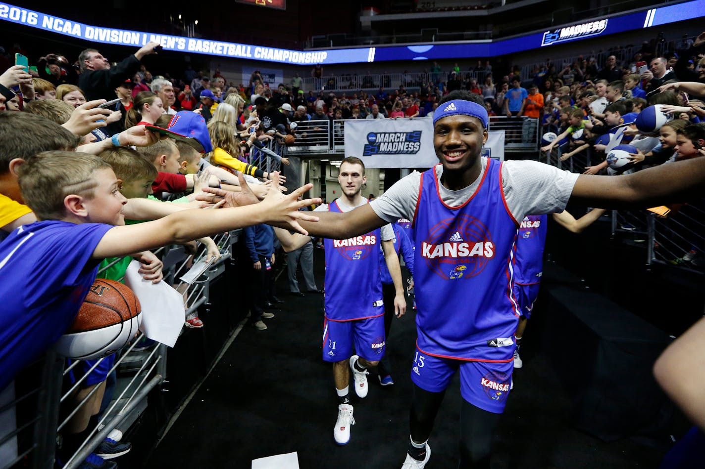 Kansas forward Carlton Bragg Jr., right, meets the fans as he takes the court during the Jayhawks' practice session on Wednesday, March 16, 2016, at Wells Fargo Arena in Des Moines, Iowa. Kansas begins play in the NCAA Tournament on Thursday against Austin Peay. (Bo Rader/Wichita Eagle/TNS)