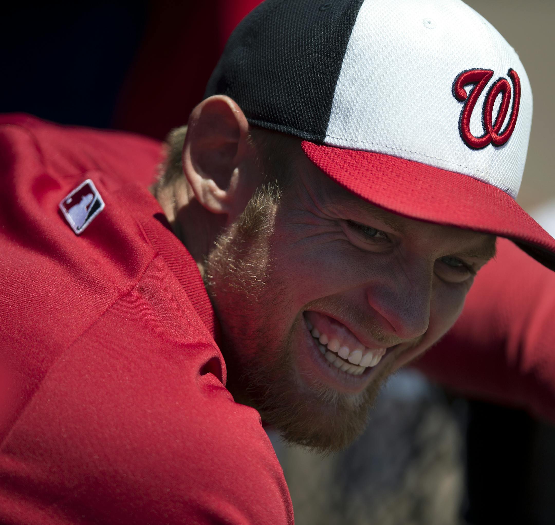 Washington Nationals pitcher Stephen Strasburg jokes around with teammates in the dugout during an exhibition spring training baseball game against the Atlanta Braves on Wednesday, March 27, 2013, in Viera, Fla. (AP Photo/Evan Vucci)