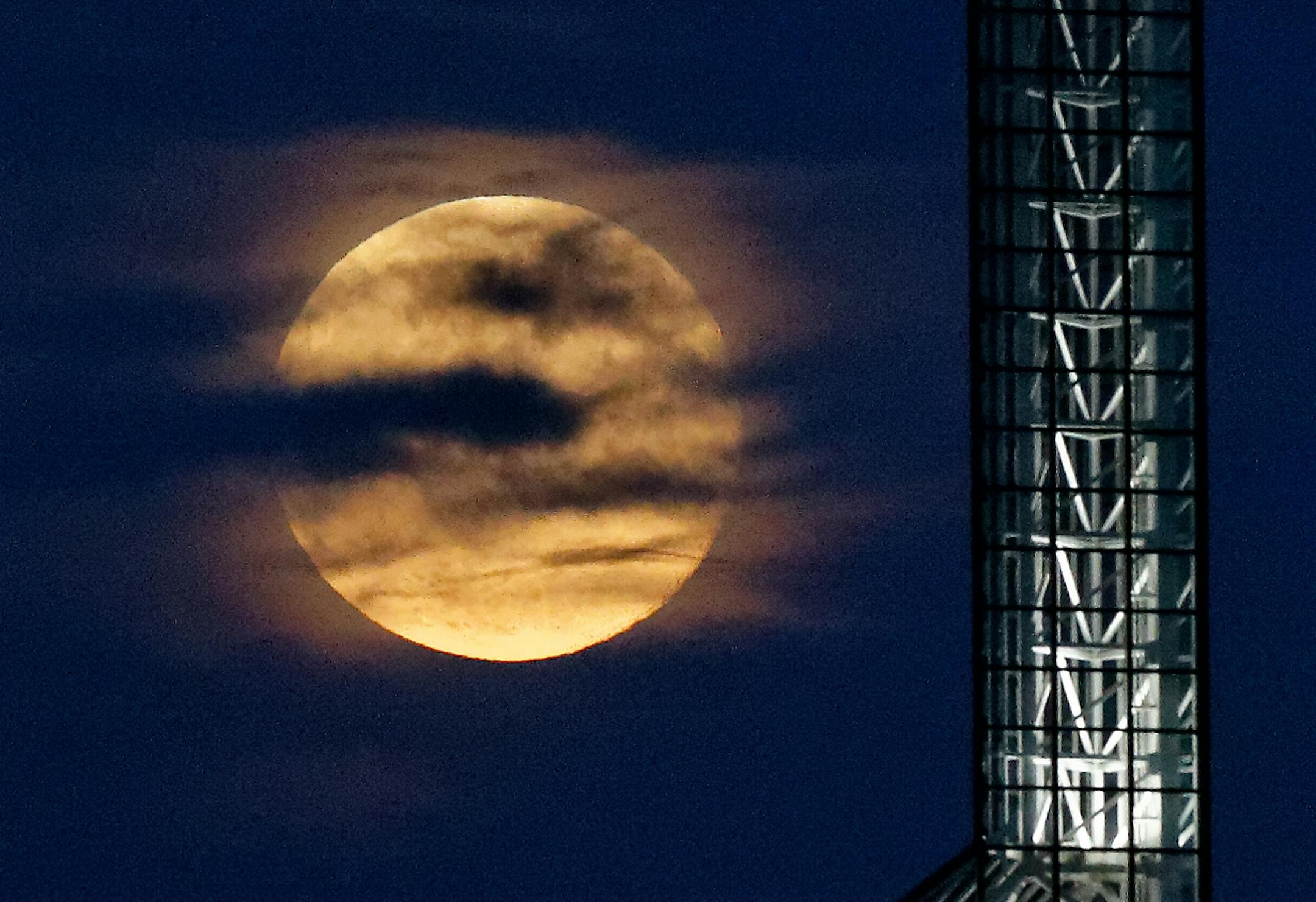 A supermoon rises over the Oregon Convention Center in Portland, Ore, Saturday, July 12, 2014. (AP Photo/The Oregonian, Mike Zacchino) MAGAZINES OUT; TV OUT; LOCAL TELEVISION OUT; LOCAL INTERNET OUT; THE MERCURY OUT; WILLAMETTE WEEK OUT; PAMPLIN MEDIA GROUP OUT