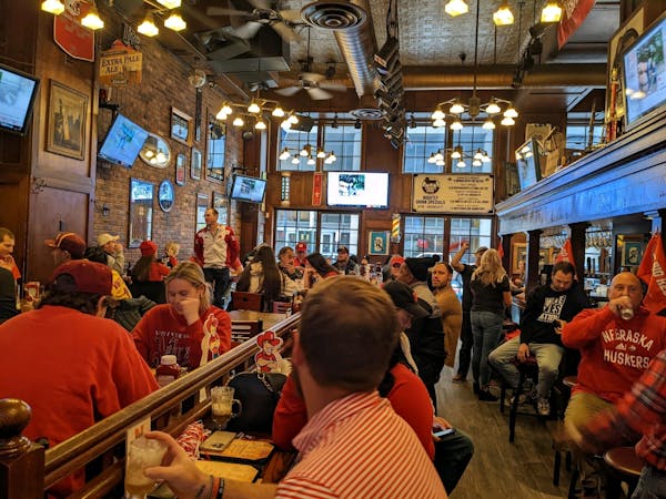 Nebraska fans wore their red at Lyon’s Pub in Minneapolis on Saturday to watch the Cornhuskers’ football game against the Gophers.