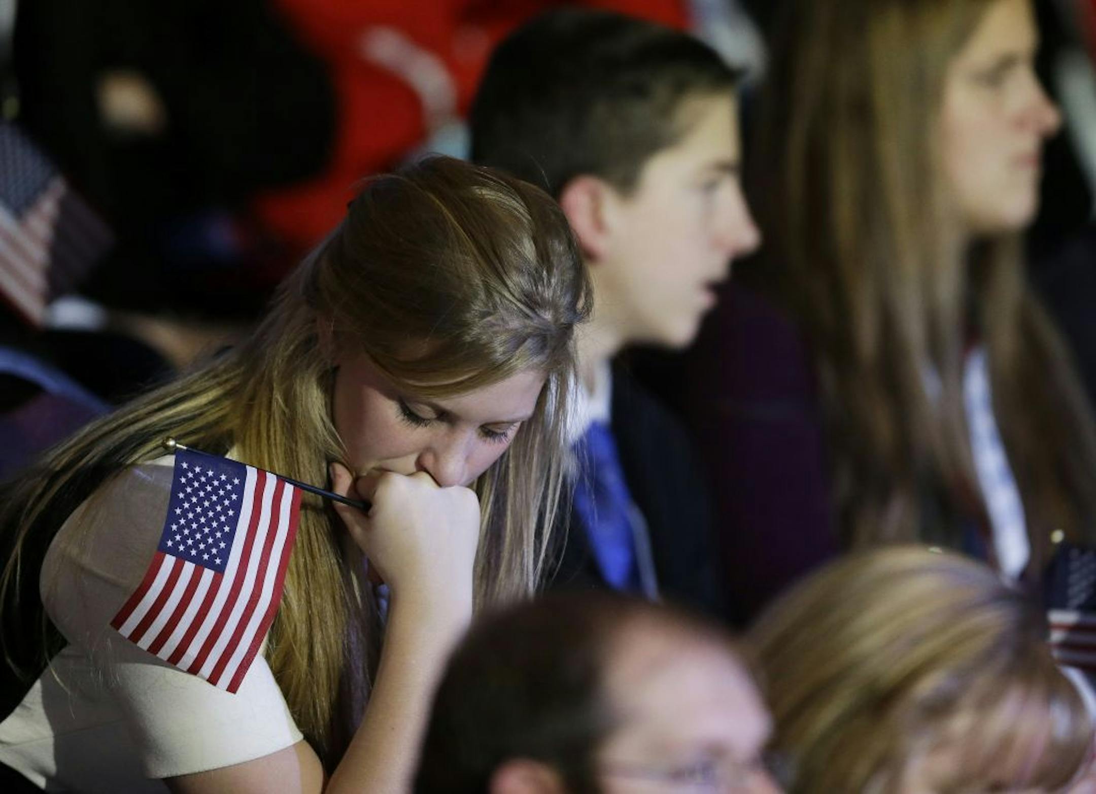 A supporter reacts to voting results displayed on a television screen during Republican presidential candidate and former Massachusetts Gov. Mitt Romney's election night rally, Tuesday, Nov. 6, 2012, in Boston.