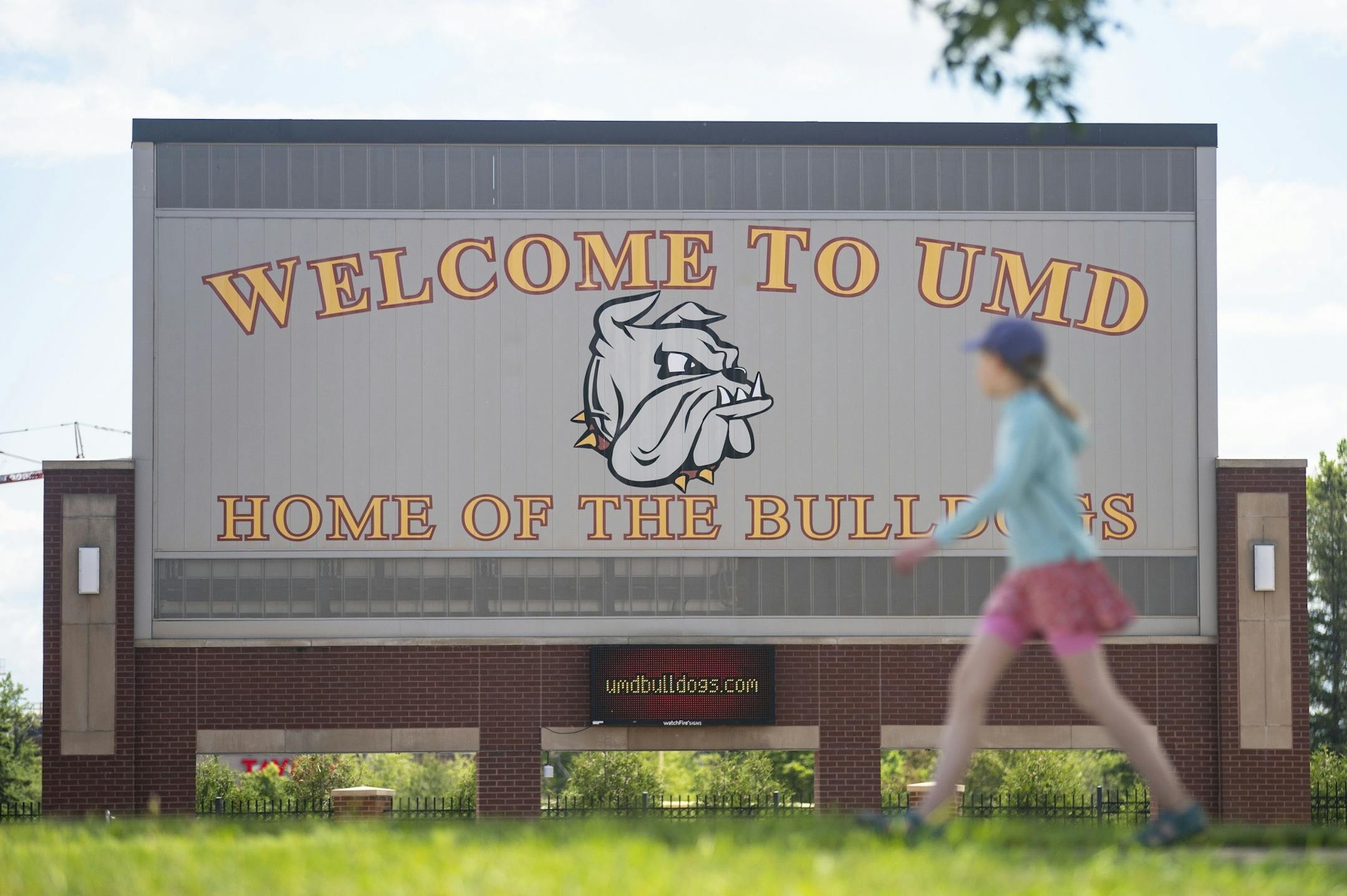 A woman walked past the University of Minnesota Duluth football stadium on Tuesday June 23, 2020.