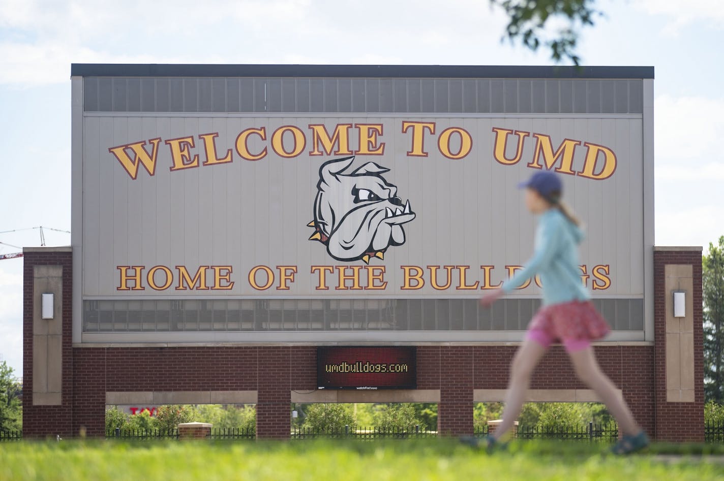 A woman walked past the University of Minnesota Duluth football stadium on Tuesday June 23, 2020.