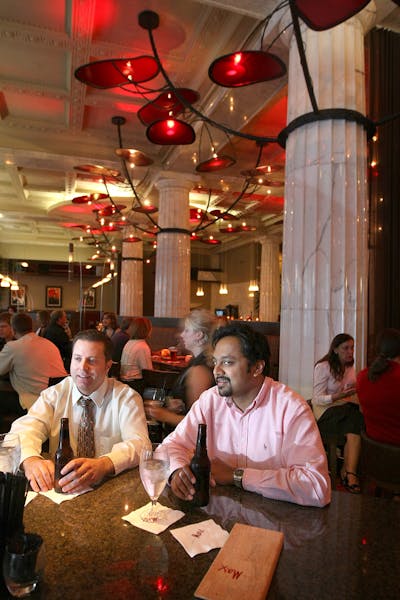 Dan Homstad and Marc Devaraj chat over a beer at the Restaurant Max bar in the Hotel Minneapolis.
