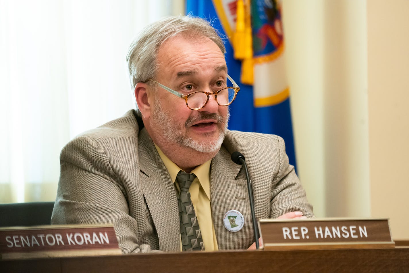 Rep. Rick Hansen, D-South St Paul, at his desk with a nameplate in the Legislature.