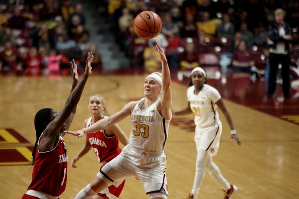 Minnesota Golden Gophers guard Carlie Wagner (33) scored over Indiana Hoosiers guard Bendu Yeaney (1) in the first half at Williams Arena Tuesday Feb 