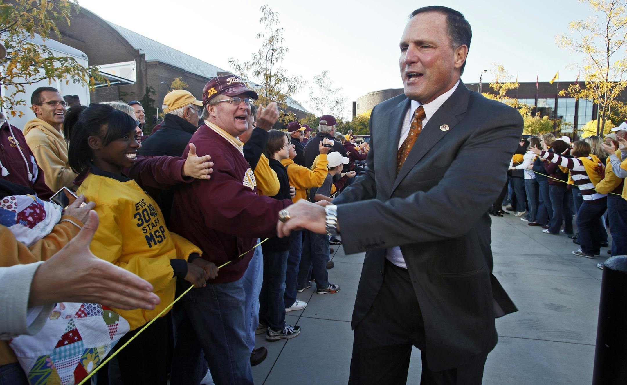 Former Gophers head coach Tim Brewster greeted fans on the 'victory walk' preceding the game against Northern Illinois, a game Minnesota won in part because of a daring call on a fourth-down play.