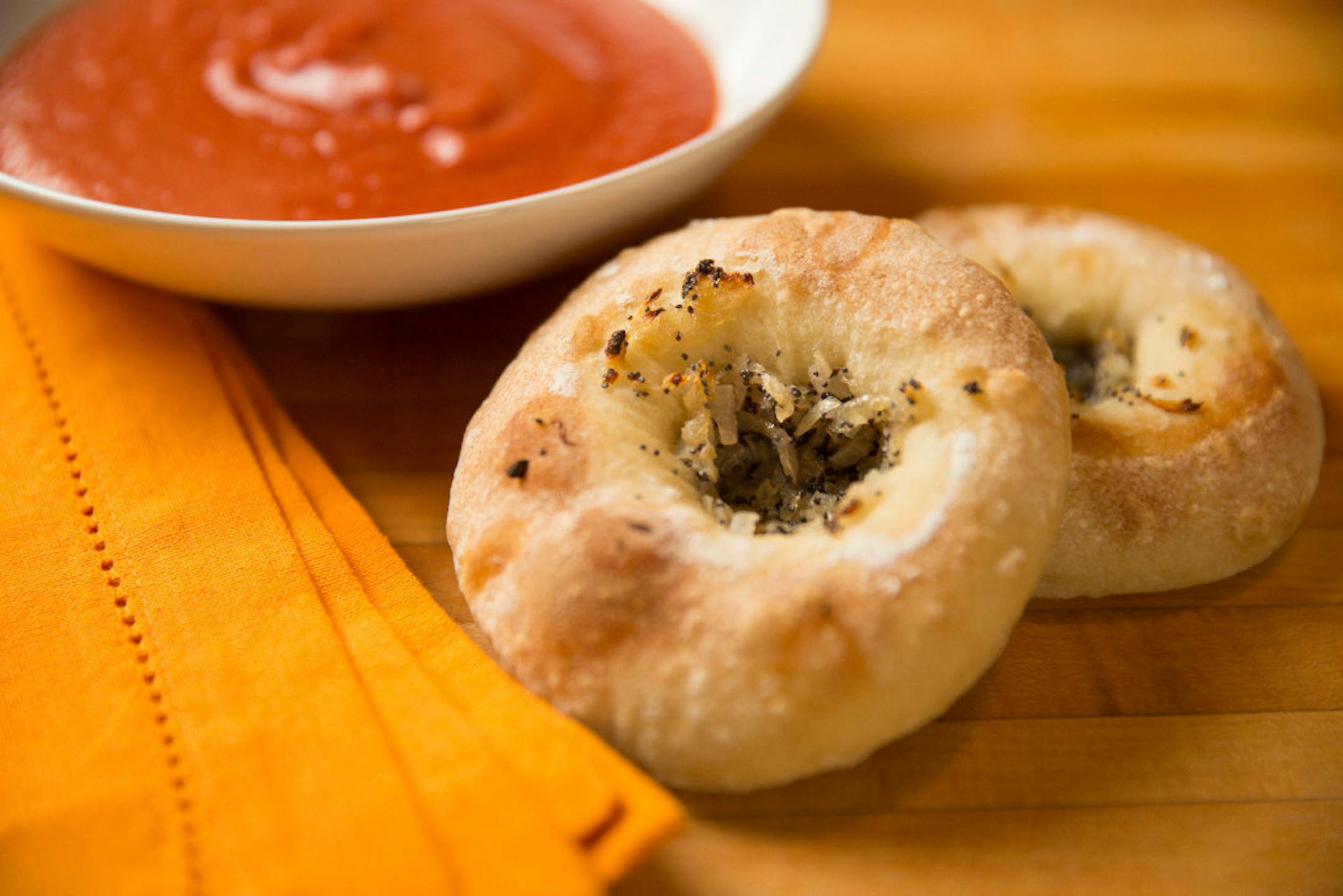 Bialys are filled with a mixture of sautéed onions and poppy seed, and the dough tips toward the salty side.