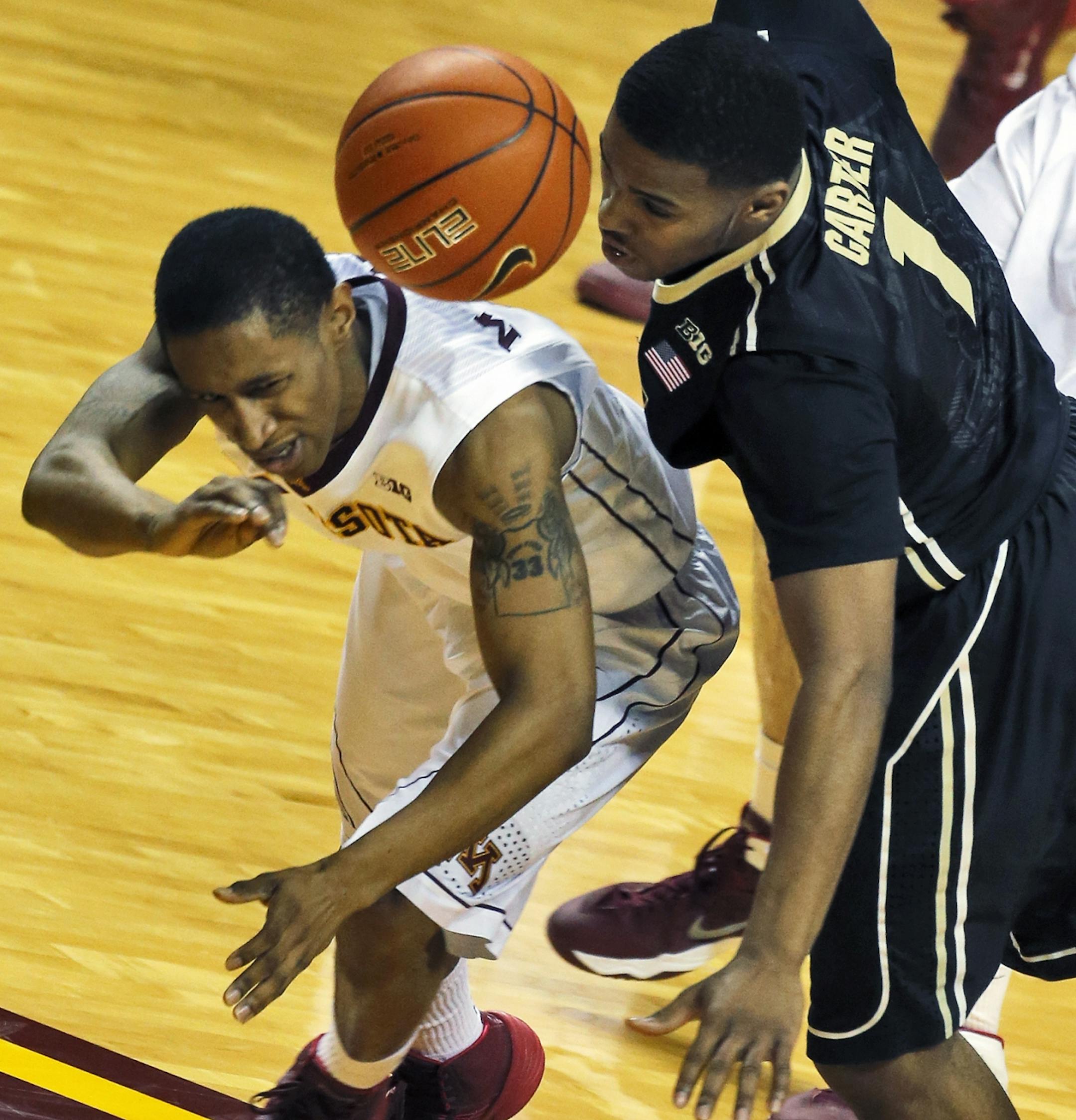 Minnesota Gophers mens basketball vs. Purdue. Minnesota won 82-79. Minneosta's DeAndre Mathieu, left, wasd fouled by Purdue's Sterling Carter as Mathieu advanced the ball upcourt. (MARLIN LEVISON/STARTRIBUNE