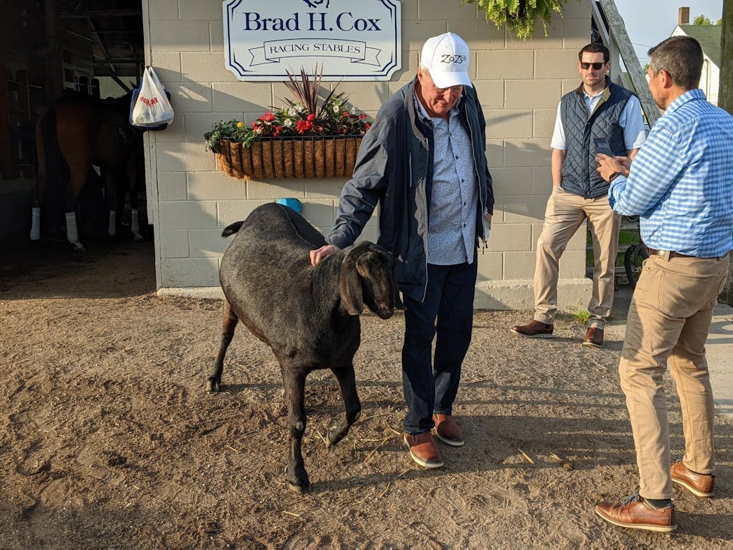 Barry Butzow of Eden Prairie, who owns Kentucky Derby contender Zozos, with Mr. Man, the resident goat at the Brad Cox stable.